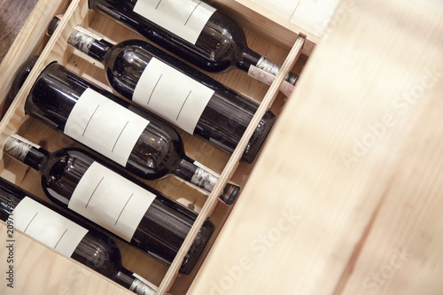Red wine bottles in wood box
