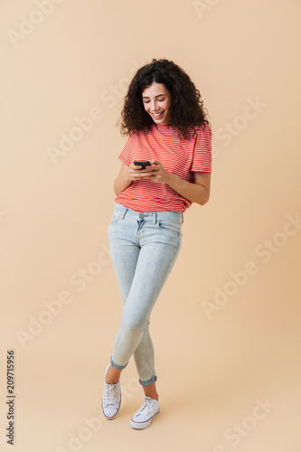 Full length portrait of a smiling casual girl