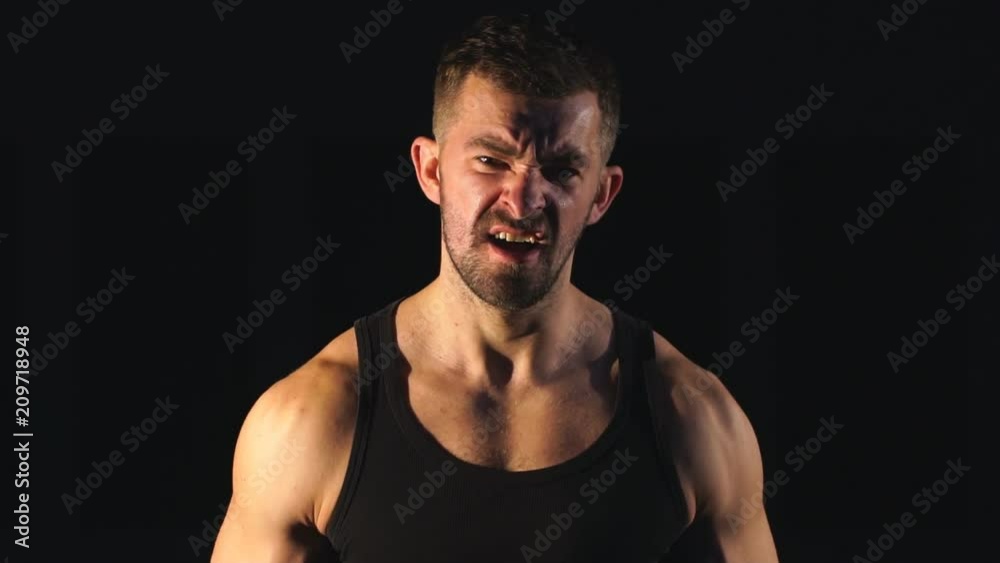 Fit Athlete Working Out Biceps at the gym on black background Fit Athlete Working Out Biceps at the gym on black background