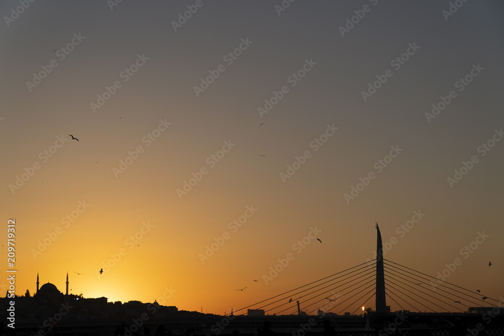 Historical and modern architecture together At Istanbul Sunset. There is a historical mosque at the left side and The Subway Bridge at the right side of the image. Historical and modern architecture together At Istanbul Sunset. There is a historical mosque at the left side and The Subway Bridge at the right side of the image.
