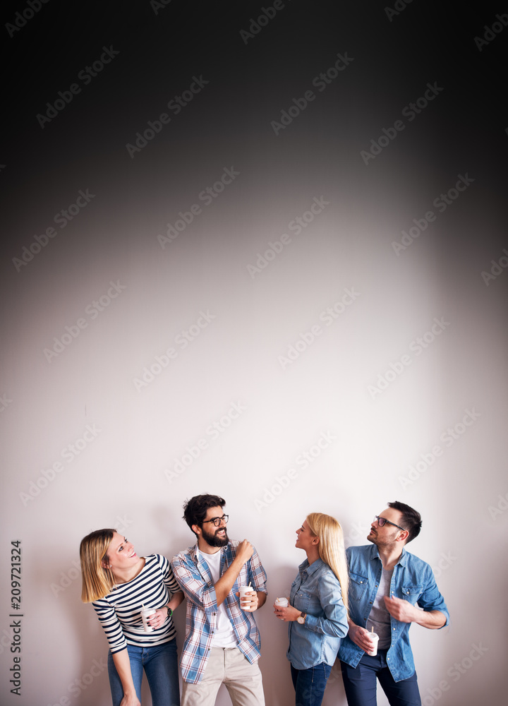Naklejka premium Group of happy young engineers is being informed they got the job as they enter the office of their new boss.
