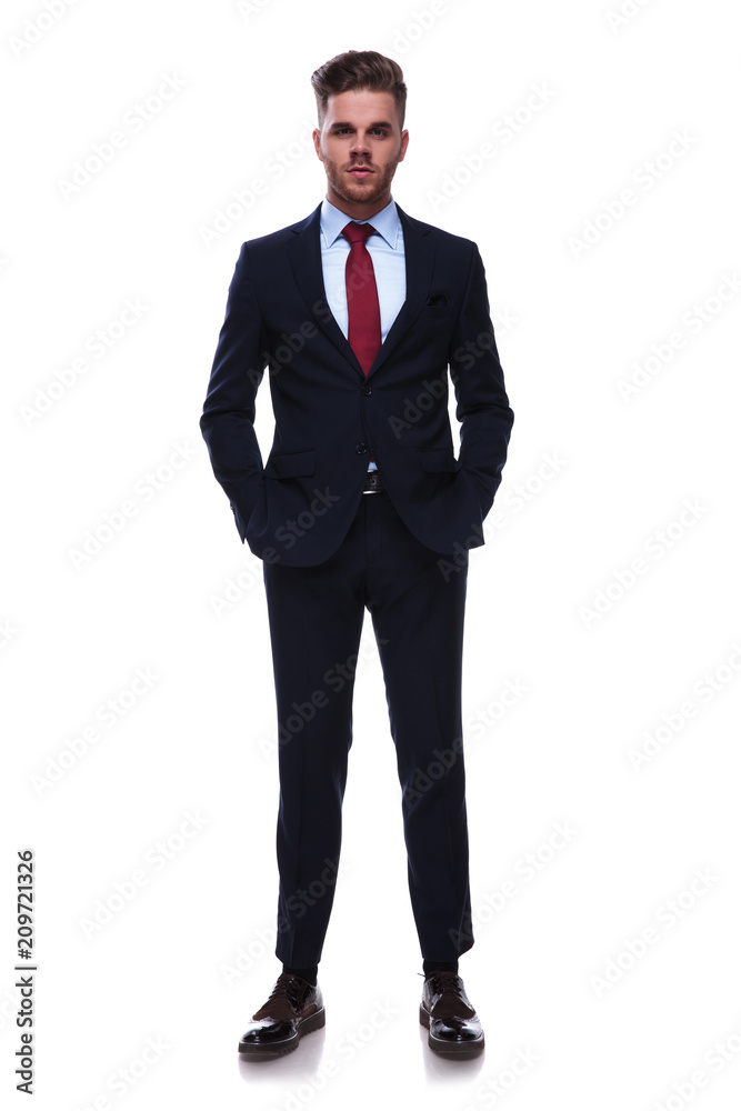 handsome relaxed businessman in navy colored suit standing handsome relaxed businessman in navy colored suit standing