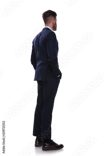 Fotografija turned businessman in navy suit looks to side