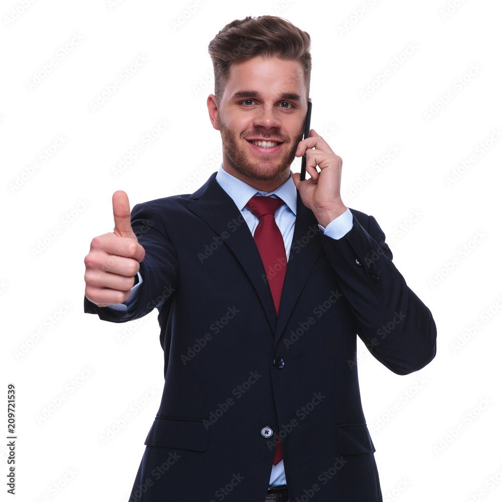 smiling businessman talks on the phone and makes ok sign smiling businessman talks on the phone and makes ok sign