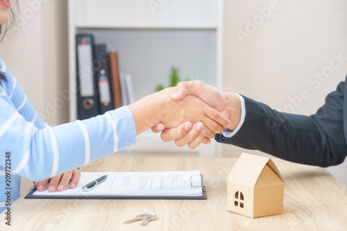 Customer or woman say yes to sign loan contract for buying new home concept - hand shaking.