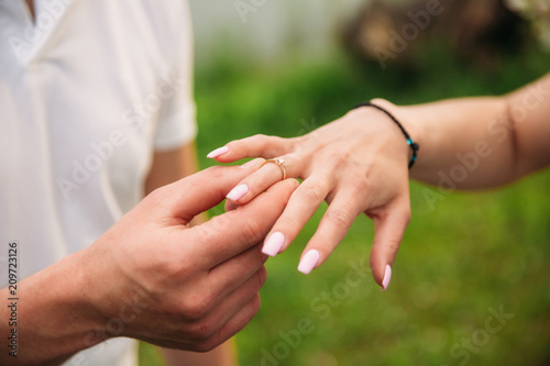 Man makes a marrige proposal to a girl. Gives her a ring for the engagement. Close-up hands