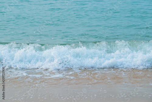 Movement of Soft Blue Ocean beach wave of the sea on the sand