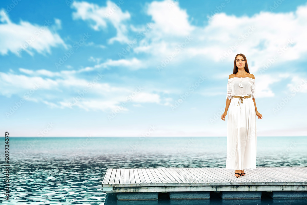 Summer time and slim woman on pier. Sea landscape with blue sky. 