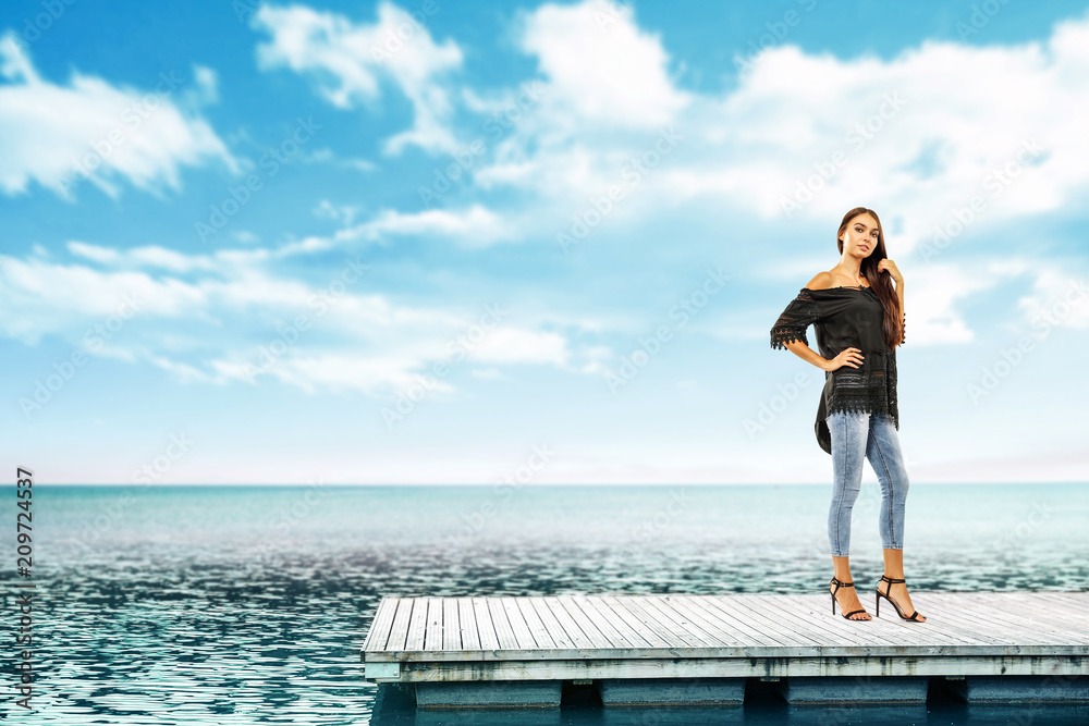 Summer time and slim woman on pier. Sea landscape with blue sky. 