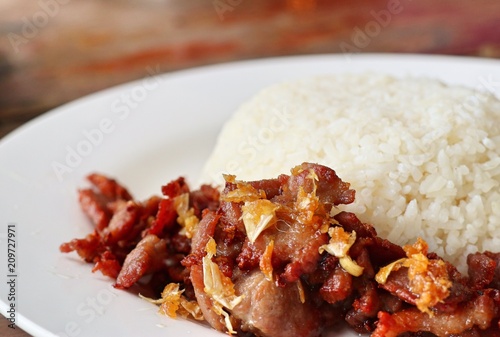 Fried pork with garlic topped with rice