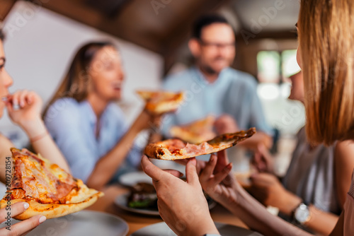Obraz na plátně Eating pizza with friends. Close-up.