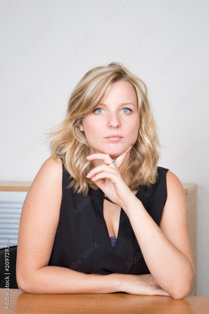 Meditative smiling businesswoman dreaming of future success at workplace