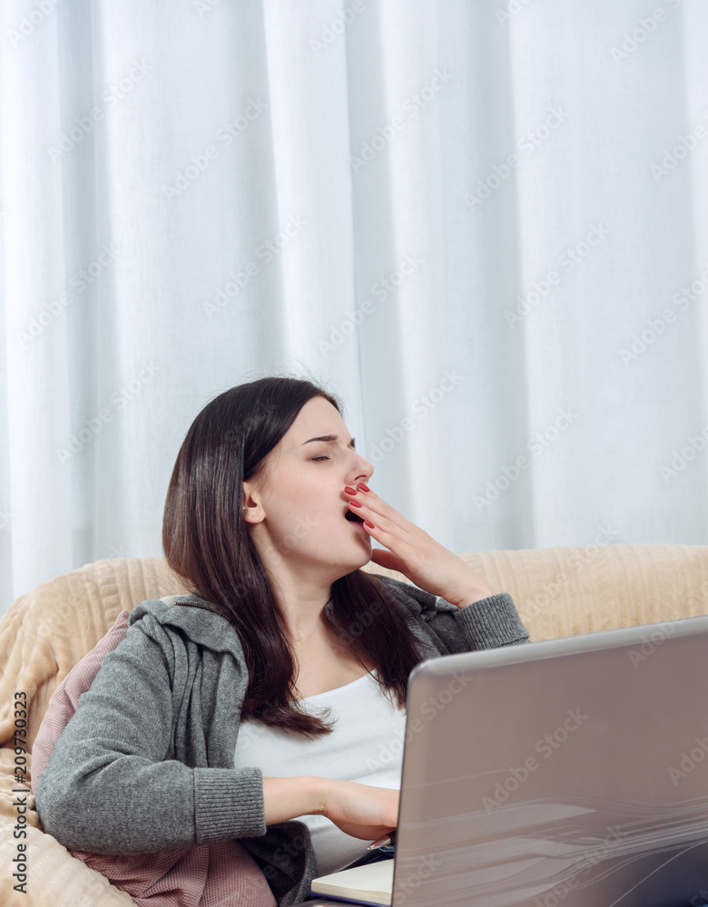 Young female student preparing for college exams at home