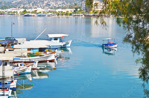 landscape of traditional fishing boats reflected on sea at Eretria Euboea Greece photo