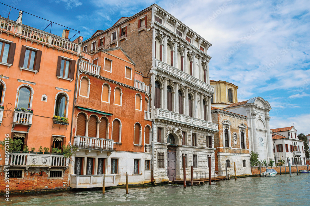 View of ancient buildings and church facing the Grand Canal, at the city center of Venice, the historic and amazing marine city. Located in Veneto region, northern Italy