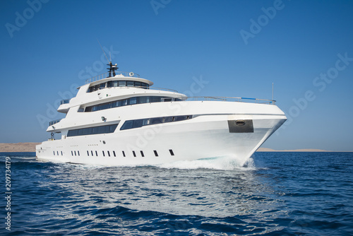 Fototapeta Luxury private motor yacht sailing at sea