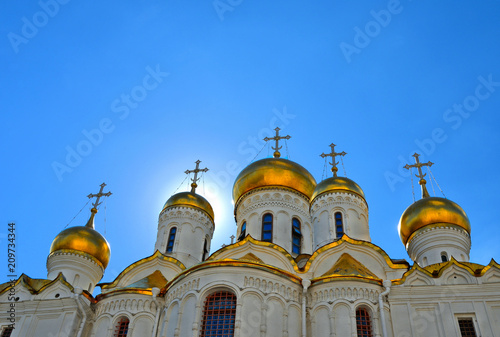 Golden domes and cross of historical old Annunciation Cathedral in Moscow Kremlin, Russia