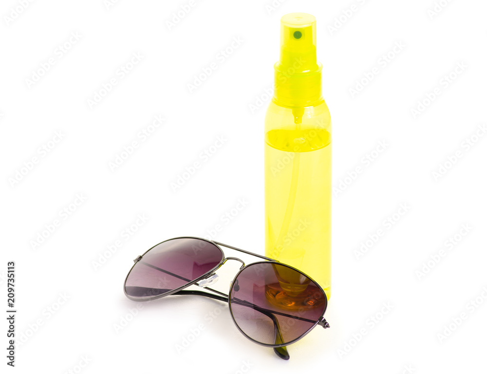 Bottle spray for suntan sun glasses on white background isolation Bottle spray for suntan sun glasses on white background isolation