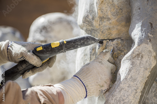 Restorer is engaged in the restoration of the statue