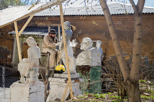 Renovator is engaged in the restoration of the statue