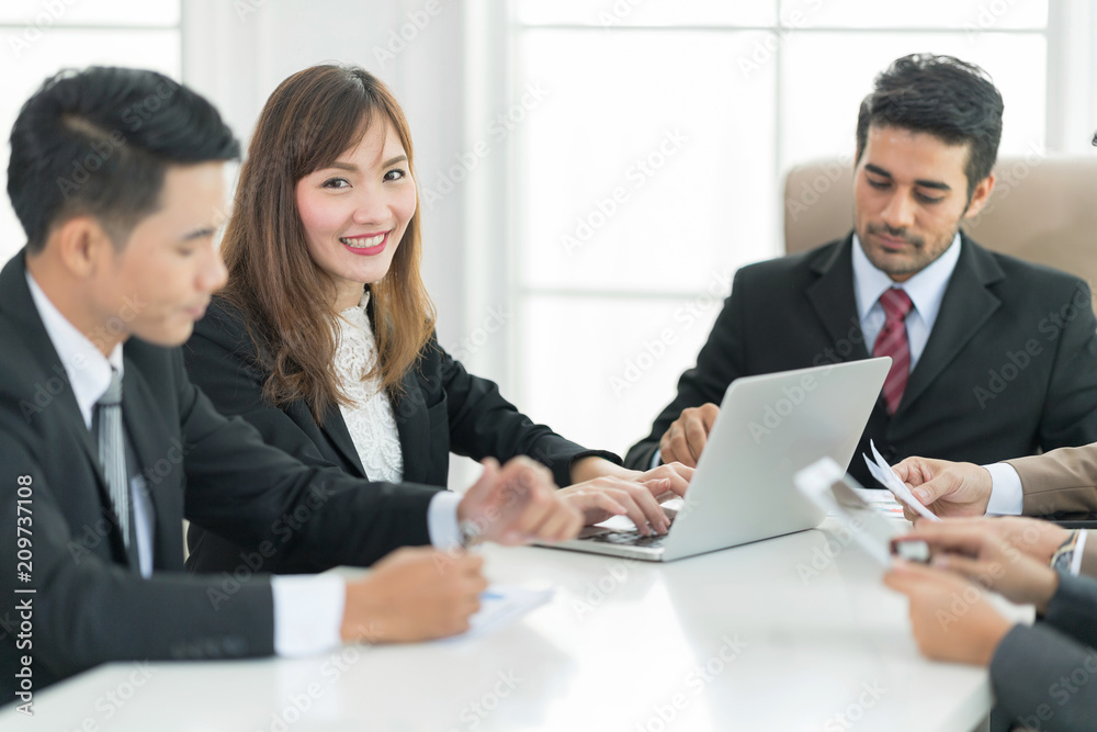 A confident business team of mixed ages and ethnicity are holding a meeting in a modern office. They are discussing ideas for their business development. A confident business team of mixed ages and ethnicity are holding a meeting in a modern office. They are discussing ideas for their business development.