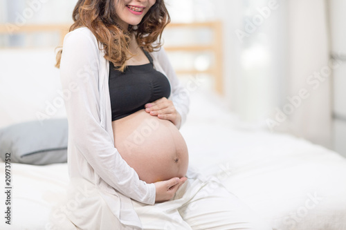 Close Up Of A Beautiful Happy Pregnant Woman With Big Belly. Pregnancy And Motherhood Moment People And Expectation Concept. In Selective Focus of Hands Touching and Hold By Love. Free Download Close Up Of A Beautiful Happy Pregnant Woman With Big Belly. Pregnancy And Motherhood Moment People And Expectation Concept. In Selective Focus of Hands Touching and Hold By Love. - GFXLoad