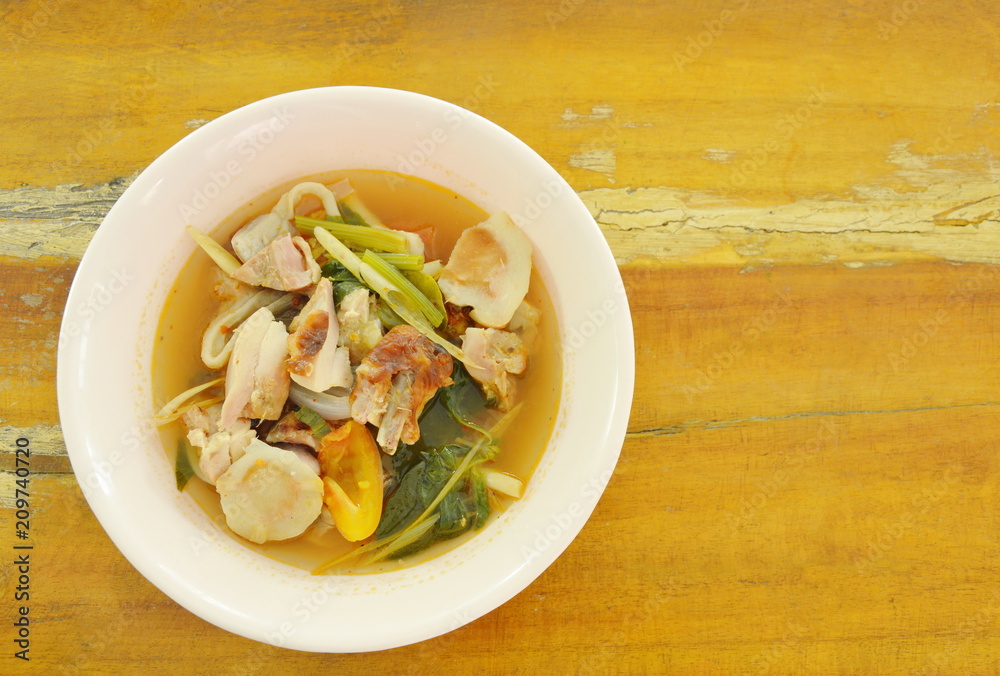 boiled grilled chicken with mushroom and tomato in tom yum spicy soup on bowl boiled grilled chicken with mushroom and tomato in tom yum spicy soup on bowl