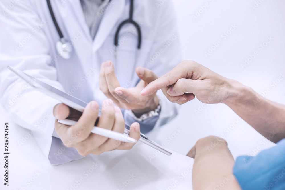 Doctor using digital tablet and ask questions of illness of patients Doctor using digital tablet and ask questions of illness of patients