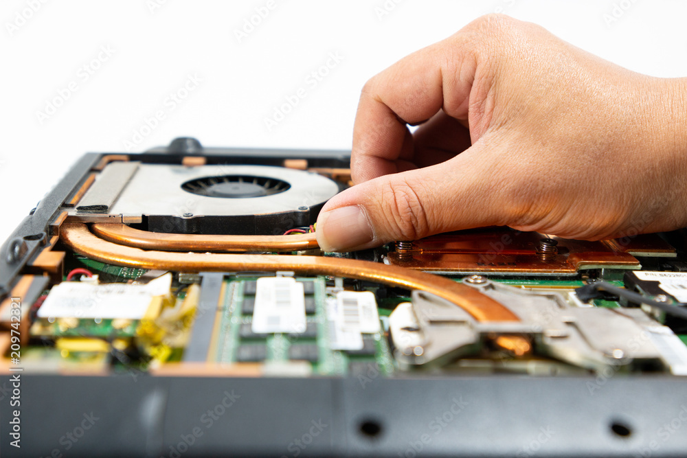 Obraz premium Computer repair technician is repairing the notebook or repair laptop.