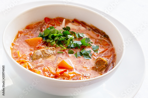 vegetables and meat soup with sour cream and lovage