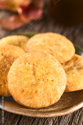 Chilean Sopaipilla nortena (made with pumpkin in the dough) deep-fried pastry, a popular snack in autumn and winter (Selective Focus, Focus through the middle of the first sopaipilla) photo