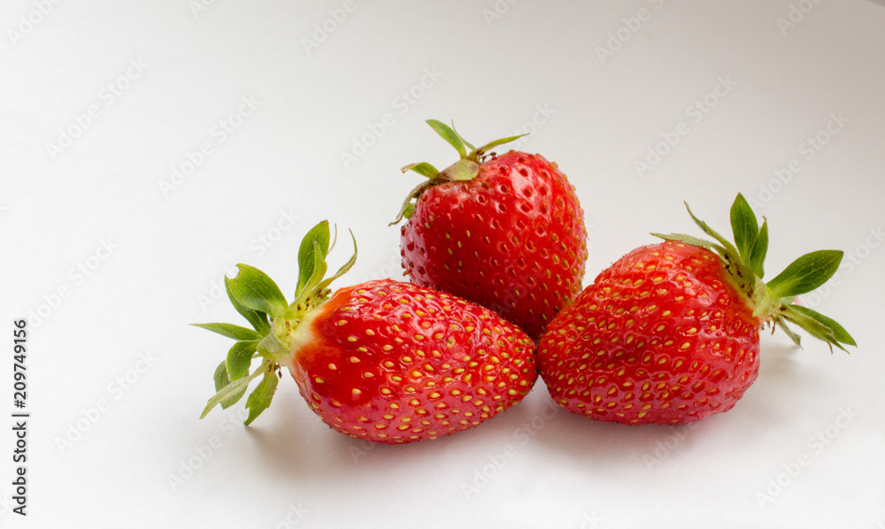 Three red strawberries at white background Three red strawberries at white background