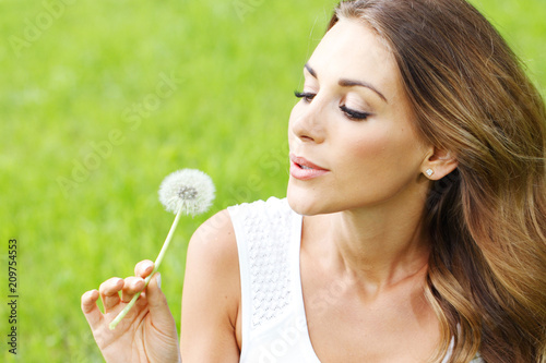 beautiful young woman with dandelion