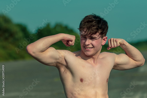 Young adult male shirtless outdoors