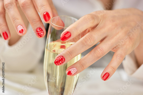 Woman hand with champagne glass. Beautiful female manicured hands and crystal glass of champagne. Concept of romance and celebration.