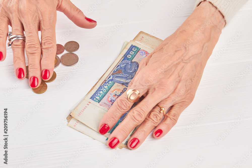 Kyat money and caucasian businesswoman hands. Burma traditional currency well-groomed hands of businesswoman. Myanmar money on white wooden background. Kyat money and caucasian businesswoman hands. Burma traditional currency well-groomed hands of businesswoman. Myanmar money on white wooden background.