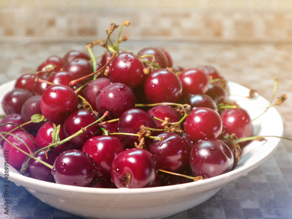 Ripe red fresh cherry in sunlight in a dish Ripe red fresh cherry in sunlight in a dish