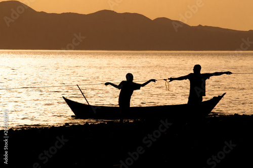 Two fishermen at sunset
