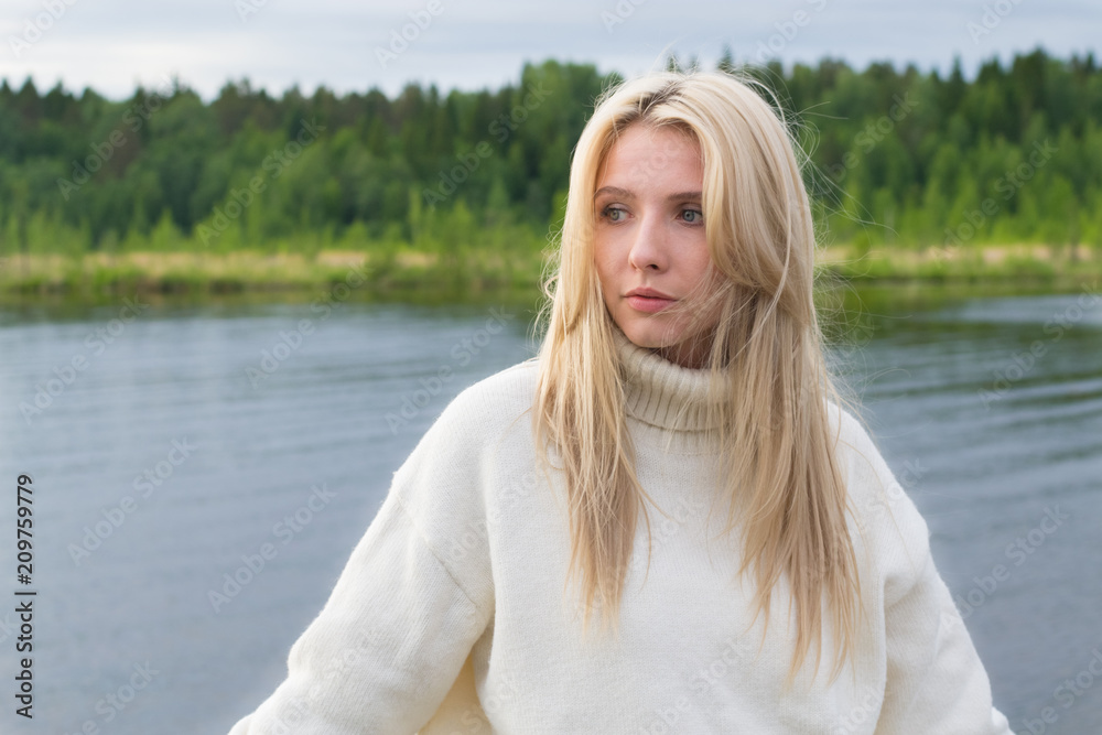 Young sad woman by lake Young sad woman by lake