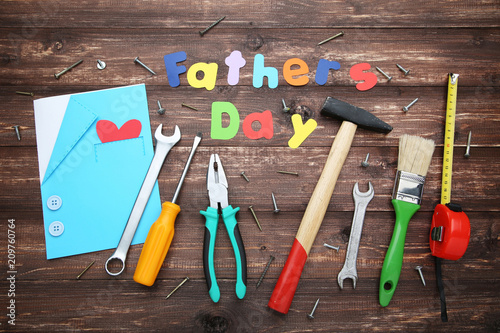 Inscription Fathers Day with different tools on wooden table