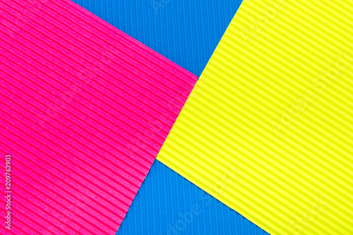 Pink blue and yellow color corrugated cardboard texture background. Trend colors, geometric cardboard paper background.