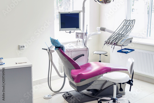 Modern patient chair and equipment in dentistry office