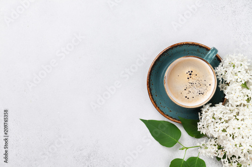 White lilac flowers and coffee cup