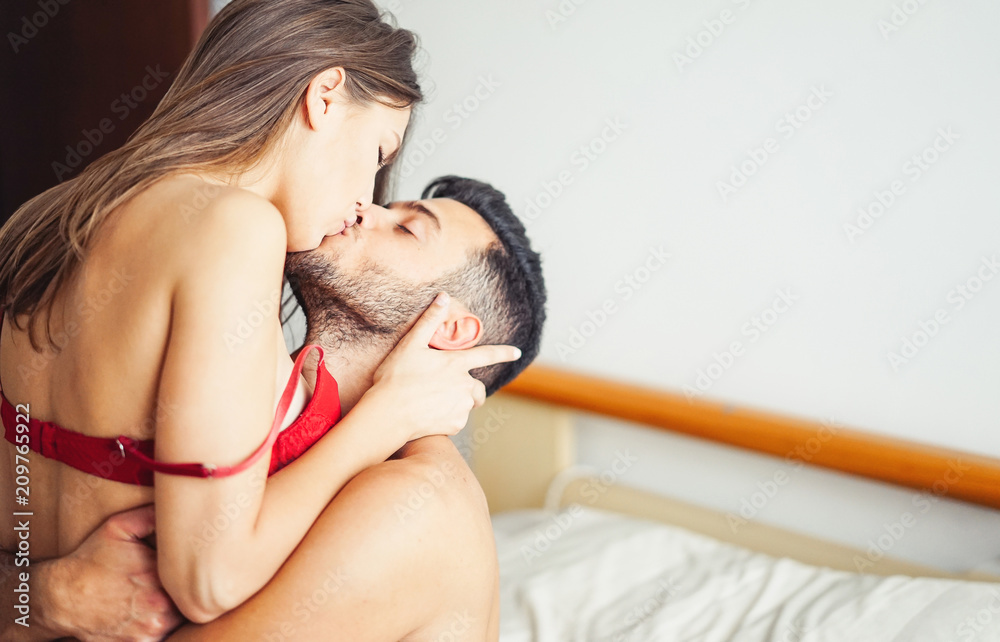 Beautiful passionate young couple having sex on the bed at home - Intimate  and sensual moments of a couple kissing in the bedroom - Relationship,  intimate, love concept Stock Photo | Adobe Stock