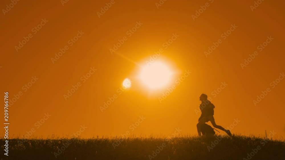 people hikers group happiness throw rucksacks up freedom run and the dog silhouette of sunlight of tourists four people walking on top of a sunset silhouette mountain. slow motion running video people hikers group happiness throw rucksacks up freedom run and the dog silhouette of sunlight of tourists four people walking on top of a sunset silhouette mountain. slow motion running video