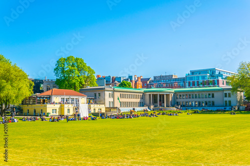Canvas Print Students are having a picnic on a field inside of the trinity college in Dublin,