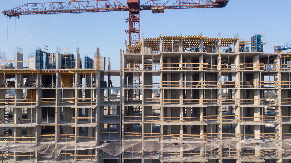 Aerial view on the building with construction cranes