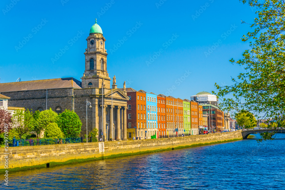 Fototapeta premium Riverside of Liffey dominated by Saint Paul's church in Dublin, Ireland