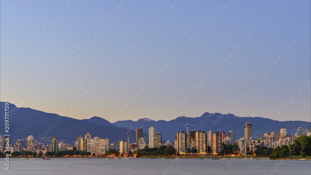 modern city with mountains and tall buildings, a huge blue sky with a sunset glow modern city with mountains and tall buildings, a huge blue sky with a sunset glow