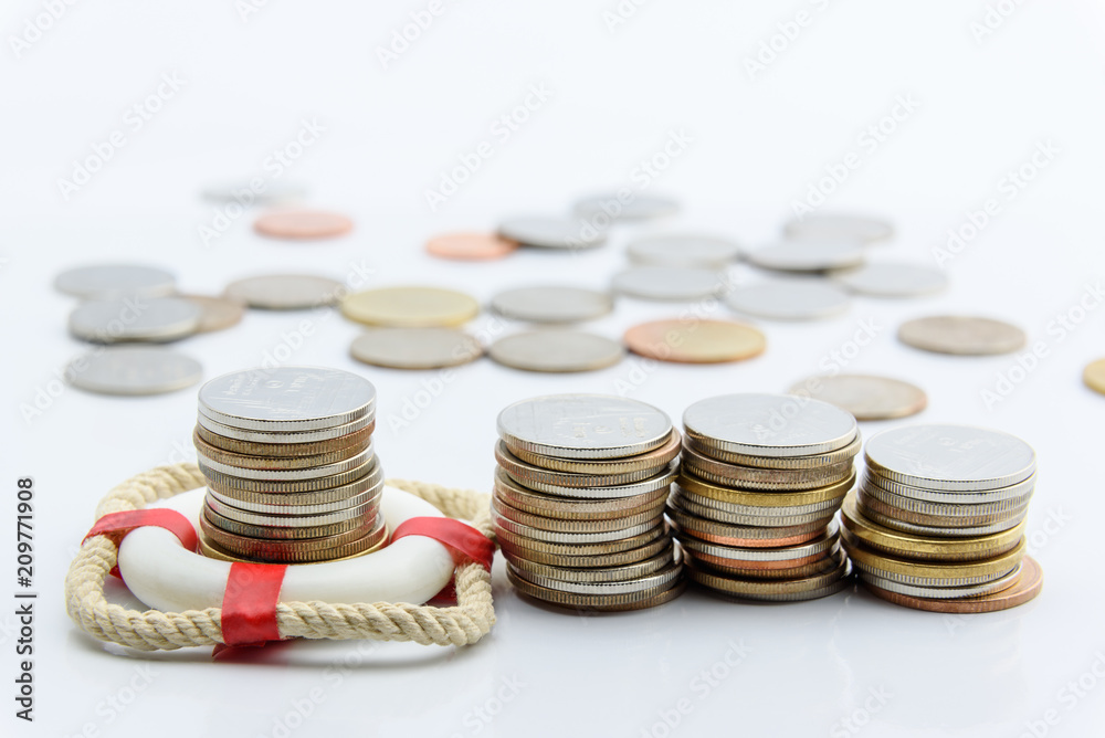 Money saving and financial wealth protection concept : Stack of coins in a red lifebuoy on white background. Securing large value of money by applying an insurance, insured assets safe & secure future Money saving and financial wealth protection concept : Stack of coins in a red lifebuoy on white background. Securing large value of money by applying an insurance, insured assets safe & secure future